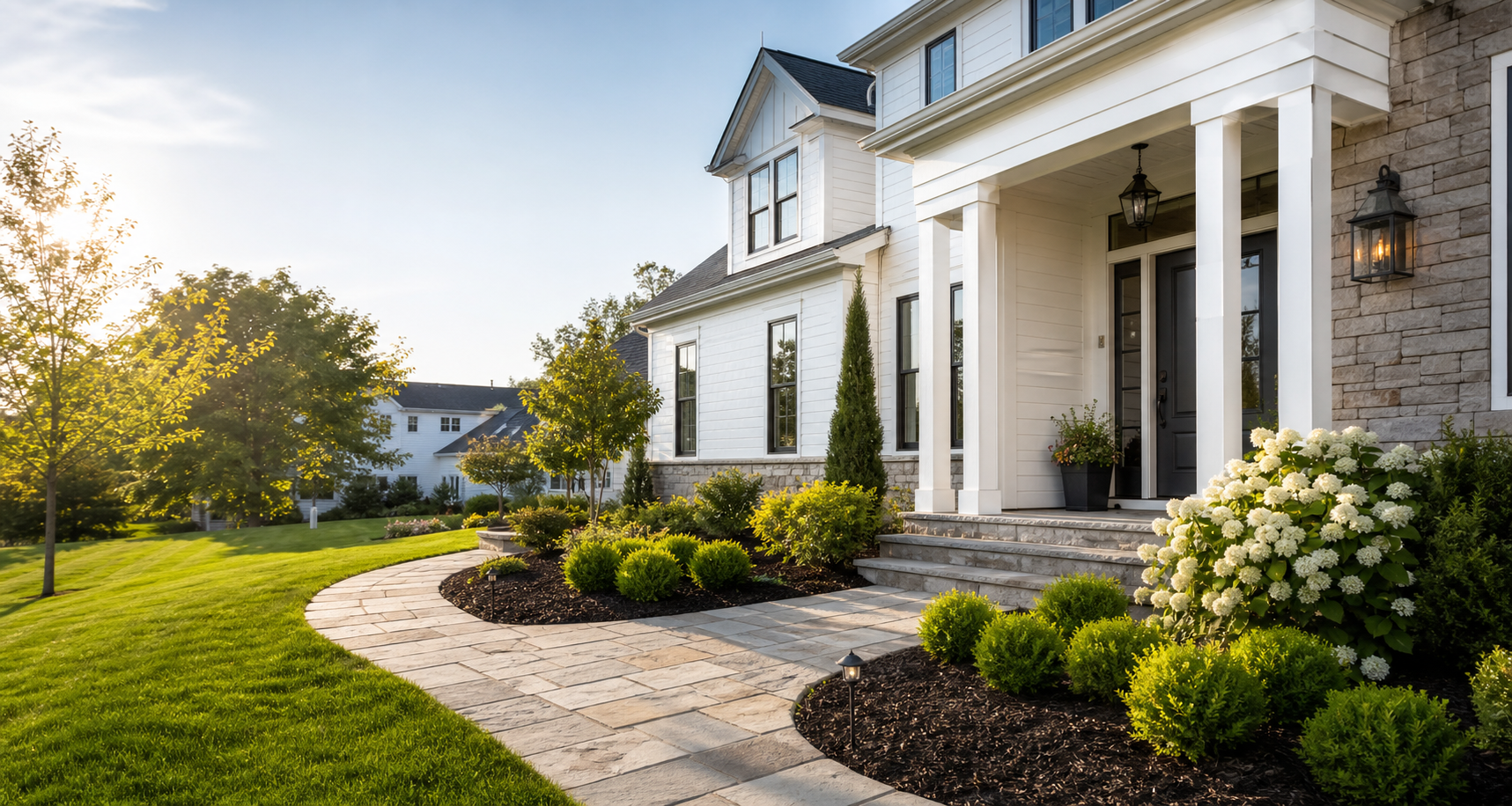 Fresh landscaping with stone walkway and a manicured front yard